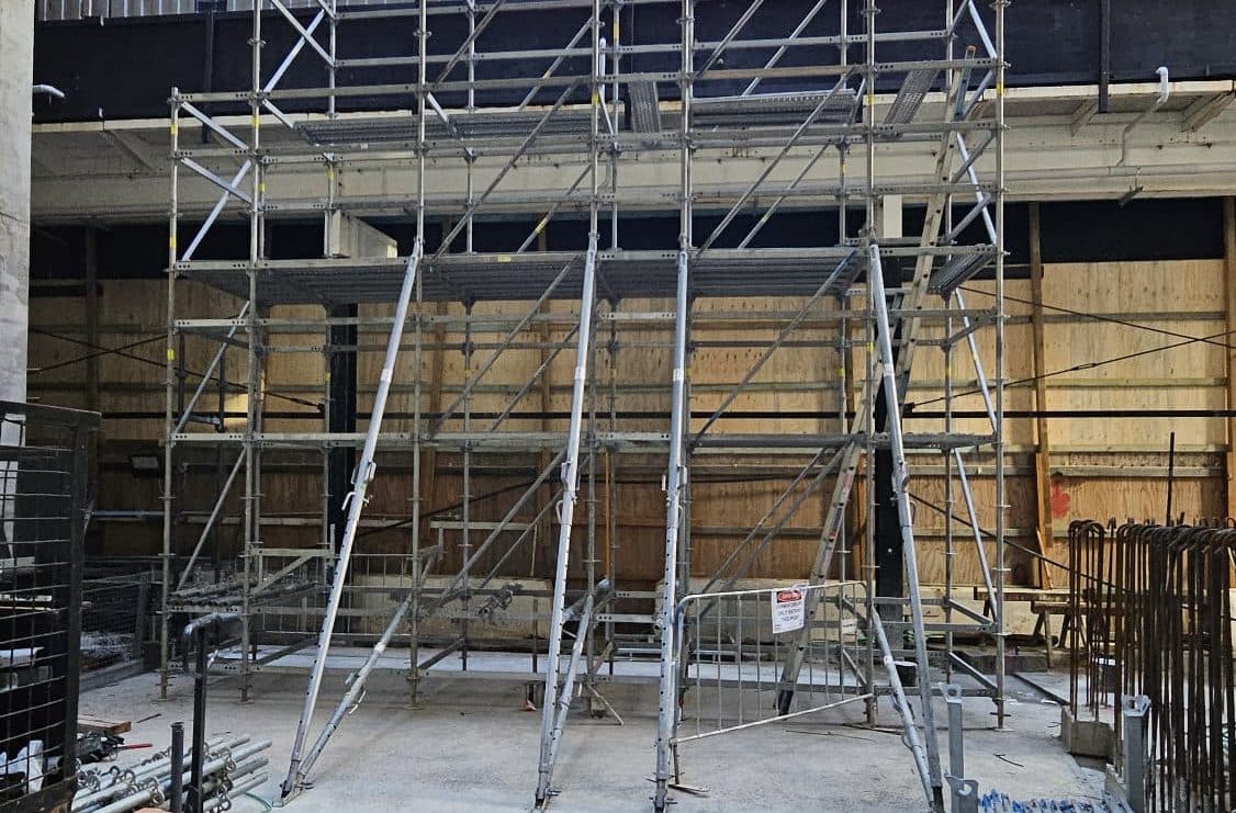 An X8 bay standing braced against a formwork wall on a job